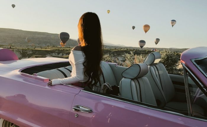 Woman Sitting in Pink Cabriolet in Cappadocia