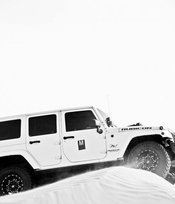 Grayscale Photo of White Jeep on Sand Dune